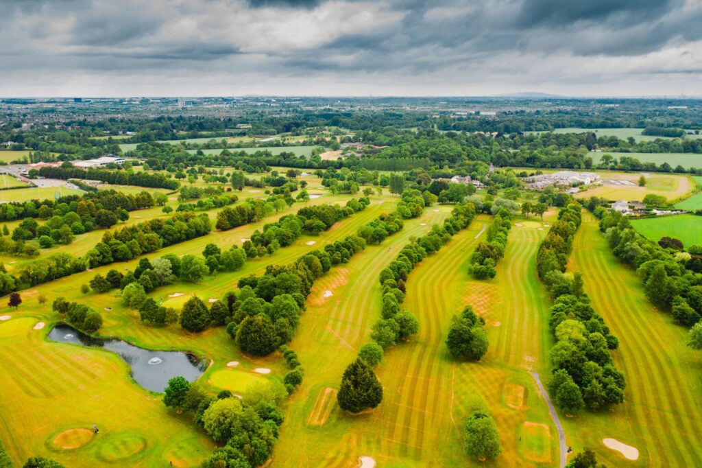 Aerial view of a parkland golf course in Ireland with tree lined fairways